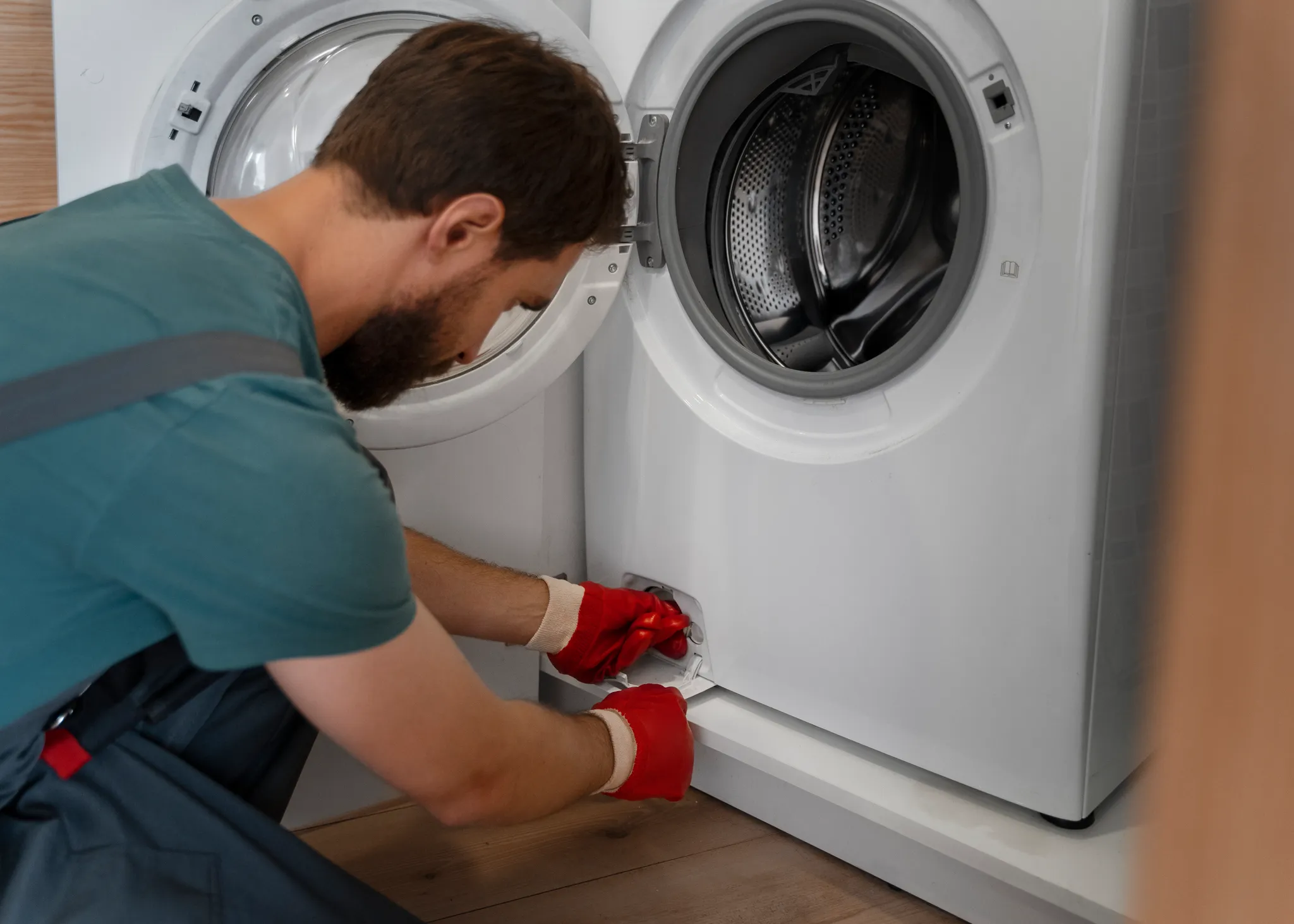 Man Installing A Washing Machine